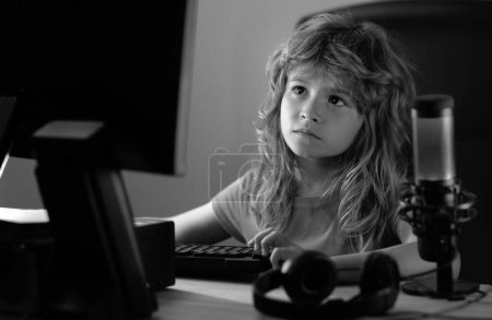 Photo for Child learning in virtual online school class. Kid working on laptop Internet at home. Child using laptop computer. Homeschooling for children. Child using computer technology in home - Royalty Free Image