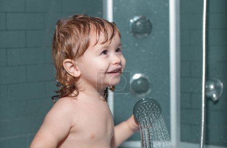 Photo for Cute child playing in bathtube. Happy baby taking a bath playing with foam bubbles. Little child in a bathtub. Infant washing and bathing. Kids care and hygiene - Royalty Free Image