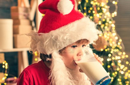 Photo for Santa Claus enjoys cookies and milk left out for him on Christmas eve. Christmas food and drink. Christmas cookies and milk. Santa Claus eating cookies and drinking milk on Christmas Eve - Royalty Free Image