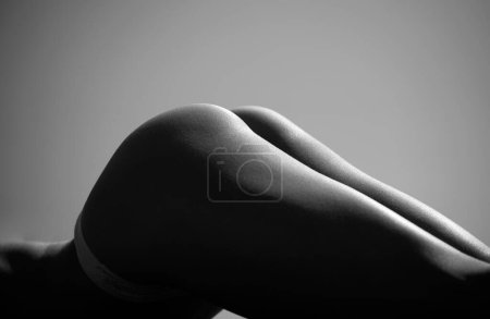 Foto de Woman posing in fashionable lingerie in studio. Back view of sexy butt. Undressed sensual woman with lace erotic lingerie - Imagen libre de derechos