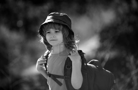 Photo for Child boy with backpack hiking in scenic mountains. Boy local tourist goes on a local hike - Royalty Free Image
