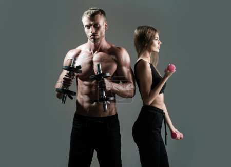 Photo for Sexy sport couple exercising with dumbbell. Slim and healthy sexy girl with strong muscular man workout. Muscular sexy couple body - Royalty Free Image