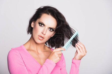 Photo for Hair loss woman with a comb and problem hair. Hairloss and hairs problems. Sad girl with damaged hair. Tangling hairs. Girl combing damaged hairs. Alopecia, dandruff. Tangled, frizzy, messy hair - Royalty Free Image