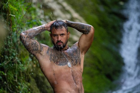Photo for Sexy Man in Alps waterfall. Man freedom lifestyle. Live in nature. Hispanic man. Calmness and relax in nature. Naked Man under the mountain river waterfall enjoying splashing. Wild Nature - Royalty Free Image
