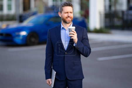 Photo for Outdoor portrait business man in classic suit. Fashionable man in suit walking outdoors. Businessman in fashion suit walking in city. Business fashion street style. Elegant man in trendy suit - Royalty Free Image