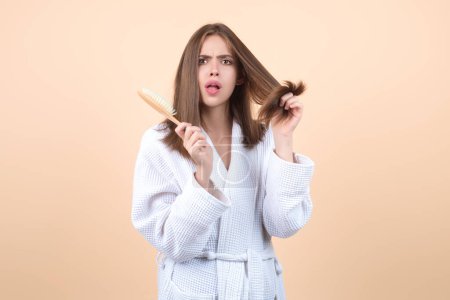 Photo for Messy hair. Brunette woman with messed hairs. Girl with bad frizzy hair. Sad woman having bad hairs. Tangling hairs is messy and tangled. Hair loss woman with a comb and problem hair. Hairloss woman - Royalty Free Image
