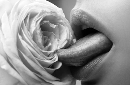 Téléchargez les photos : Lips with lipstick closeup. Beautiful woman lips with rose. Girl blowjob with tongue, vagina symbol - en image libre de droit