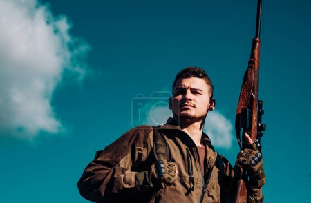 Photo for Close up Portrait of hamdsome Hunter. Hunter with shotgun gun on hunt - Royalty Free Image
