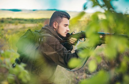 Photo for Hunter with shotgun gun on hunt. Hunter with Powerful Rifle with Scope Spotting Animals - Royalty Free Image