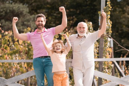 Photo for Excited grandfather father and son outdoors. Three men generation - Royalty Free Image