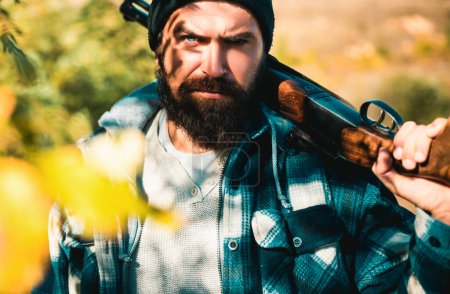 Photo for Poacher in the Forest. Hunting Licenses. Hunting is the practice of killing or trapping animals. Hunter with shotgun gun on hunt. Closed and open hunting season - Royalty Free Image
