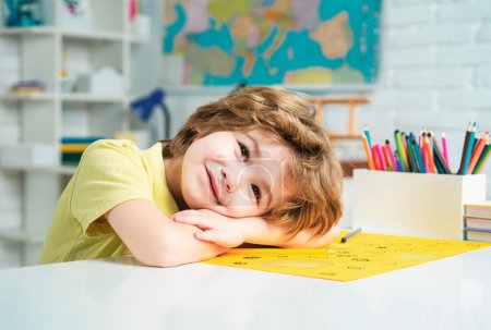 Photo for Portrait of elementary pupil looking at camera. Schoolkid or preschooler learn. Portrait of Pupil of primary school study indoors. Home schooling - Royalty Free Image