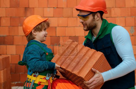 Photo for Brothers are building together. Brbuilder work with brick layer. Early childhood education concept - Royalty Free Image
