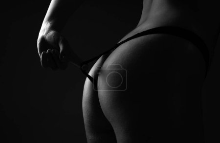 Foto de Intimacy concept. Cropped close up buttocks, lover in bikini with sexy butt. Nice ass. Sexy woman in underwear with perfect curves. Female ass in lingerie. Firm buttocks - Imagen libre de derechos