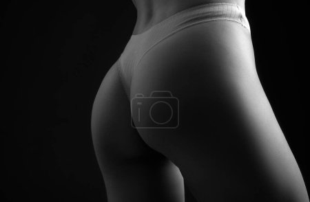 Foto de Sexy female ass in white black panties. Sensual attractive young womans ass - Imagen libre de derechos