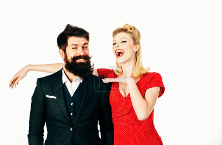Photo for Beautiful woman with luxury hairstyle wearing red dress and handsome bearded man isolated at white background. Crazy happy couple in love play tricks and have fun together - Royalty Free Image