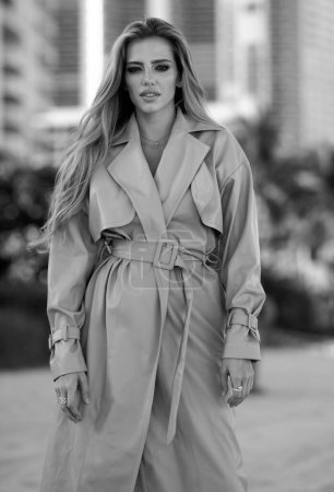 Photo for Young elegant woman in trendy coat. Fashionable woman in a coat. Fashion photo stylish woman in trench coat on street outdoor - Royalty Free Image