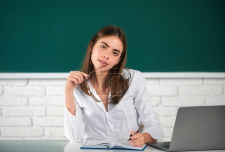 Photo for Portrait of female university student study lesson at school or university. Female freelancer or a student with laptop computer - Royalty Free Image