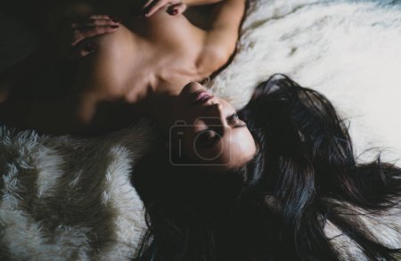 Photo for Female breasts smooth skin. Sexy girl sexual stimulation nipples. Erotic massage. Perfect breasts. Waiting for you. Orgasm and foreplay. Sexy attractive seductress. Sexy woman relaxing on fluffy bed. - Royalty Free Image