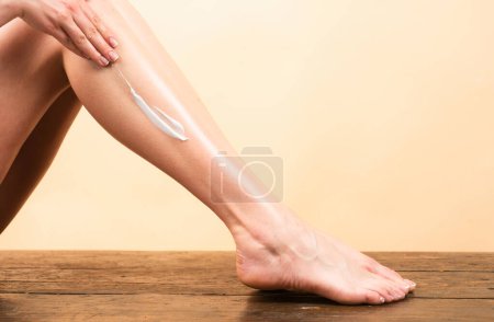 Photo for Cosmetic cream on woman leg with clean soft skin. Applying moisturizer cream on legs. Cellulite or anti cellulite treatment. Body care and spa salon concept - Royalty Free Image