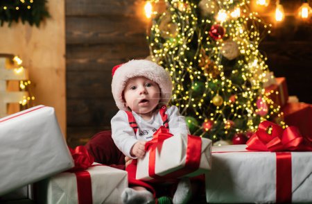 Photo for Baby in Santa clothes and Christmas hat - Royalty Free Image