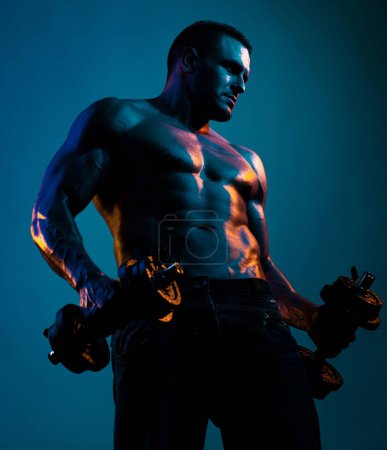 Foto de Ejercicios musculares con pesas sobre luz de neón - Imagen libre de derechos