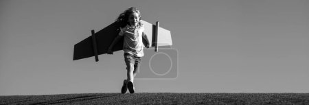 Photo for Banner with spring kids portrait. Child boy playing pilot on the sky blue background. Kid dreaming. Child playing with toy jetpack. Kid pilot having fun at park - Royalty Free Image