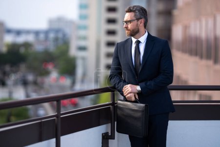 Photo for Business man goals. Business success of businessman outdoor. Handsome successful businessman in elegant suit outdoors. Business man with briefcase on city background - Royalty Free Image