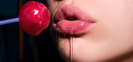 Photo for Sexy blow jobs symbol. Mouth licking lollipop, red female glossy lips and pink candy lollipop. Orgasm concept - Royalty Free Image