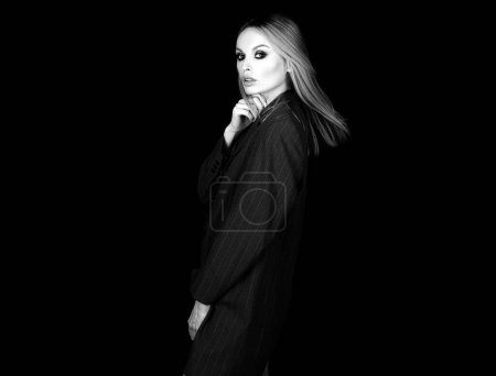 Photo for Seductive woman in sexy office suit on naked body on dark background. Business female style concept - Royalty Free Image