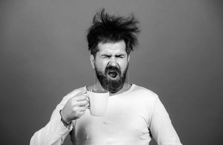 Photo for Man drinking coffee. Morning guy, wake up early in the morning on day, lifestyle daily concept. Sleepy shaggy guy in the morning - Royalty Free Image