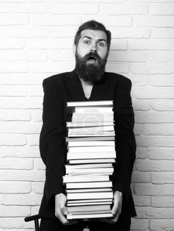 Photo for Funny teacher or professor with book stack. Thinking serious mature teacher. Mature professor, middle aged teacher, bearded fun man - Royalty Free Image