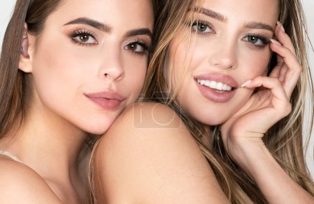 Photo for Portrait of two cheerful young women. Two beautiful young women with perfect skin in the studio. Skincare facial treatment, beauty salon - Royalty Free Image