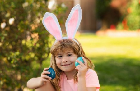 Photo for Child boy hunting easter eggs. Kid with easter eggs and bunny ears outdoor. - Royalty Free Image