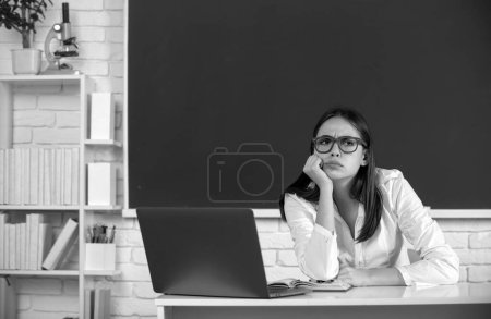 Photo for Sad serious and concerned school girl. High school student learning english or mathematics in class - Royalty Free Image