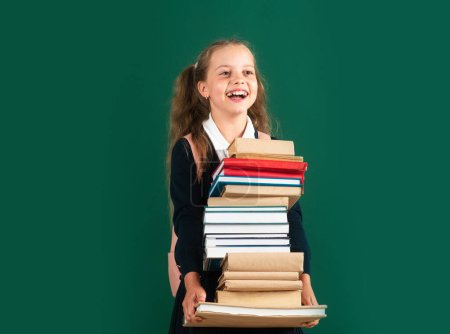 Photo for Happy teenage school child hold books green background, knowledge day - Royalty Free Image