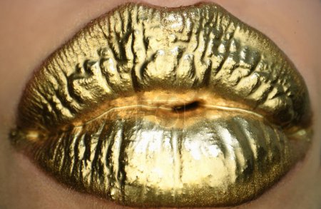 Photo for Cosmetics and make-up. Gold lips lipstick and gloss. Sexy and sensual lips. Golden lips closeup. Golden effect on the lips - Royalty Free Image