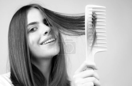 Photo for Woman brushing straight natural hair with comb. Girl combing long healthy hair with hairbrush. Hair care beauty concept. Brushing Hair - Royalty Free Image