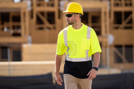 Photo for Worker man on the building construction. Construction site worker in helmet work outdoors. Builder worker working on construction site. Construction site worker outdoor portrait - Royalty Free Image