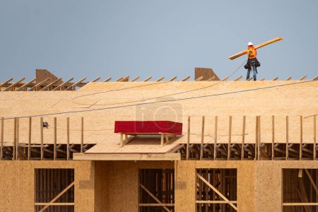 Photo for Roofing construction. Roofer roofing on roof structure. Roofing Wooden House Frame. Worker roofer builder working on roof at construction site. Construction builders Roofing - Royalty Free Image