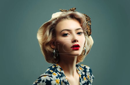 Photo for Caucasian blond model posing in retro fashion and vintage concept studio shoot. Pin up woman portrait. Beautiful retro female in polka dot dress with red lips and manicure nails and old fashion - Royalty Free Image