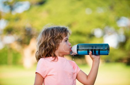 Photo for Sporty boy drink water from sport bottle. Fitness kids, health and energy. Healthy kids lifestyle. Sport for little children - Royalty Free Image