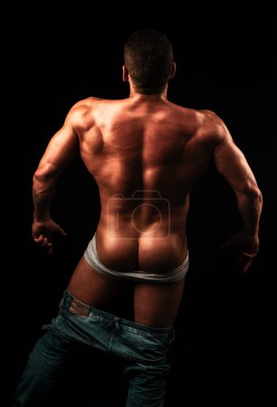 Photo for Naked sexy man with strong body and bare torso. Muscular back. Fashion gay with sexy back. Mens buttocks and powerful shoulders. Undressed handsome gay. Panties off. Mens underwear undress - Royalty Free Image