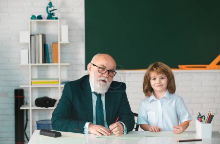 Photo for Education and learning. Teacher and pupil in school. Schoolboy in classroom - Royalty Free Image