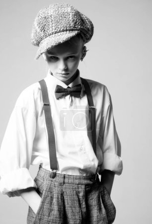 Photo for Jazz step fashion. vintage english style. retro fashion model. vintage charleston party. suspender and bow tie. old fashioned child in checkered beret. teen girl in retro male suit. In her own style. - Royalty Free Image