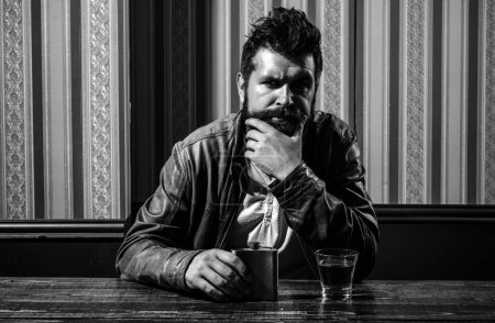 Photo for Man with beard holds glass brandy. Man holding a glass of whisky. Handsome stylish bearded man is drinking whiskey. Barbershop, shaving. Thinking to drink or not to drink - Royalty Free Image