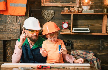 Photo for Father and his son working together in a wooden workshop - Royalty Free Image