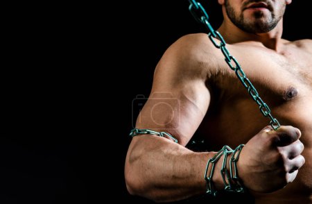 Photo for Naked torso man with chain on hand. Broken Chain. Freedom Concept . Brutal man bodybuilder athlete holding a chain on a black background - Royalty Free Image