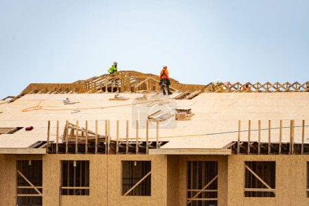 Photo for Wooden roof beam from framework. House roof at construction site. Roofer working on roof structure of building on construction site. Wooden roof beams - Royalty Free Image