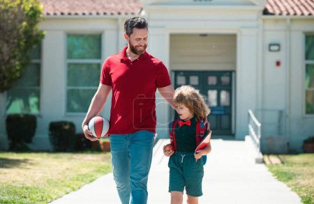 Photo for Father supports and motivates son. Kid going to primary school. Teachers day - Royalty Free Image